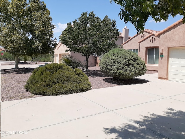view of front of property featuring stucco siding and an attached garage