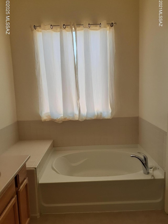 full bath with a bath, a wealth of natural light, and vanity