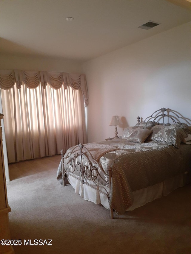 bedroom with carpet floors and visible vents