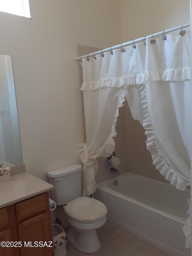 bathroom featuring tile patterned flooring, shower / tub combo, toilet, and vanity