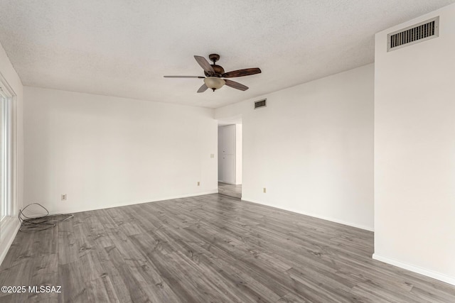1363 W Dawn Dr, Tucson, AZ 85704 - unfurnished room featuring wood finished floors, a ceiling fan, a textured ceiling, and baseboards