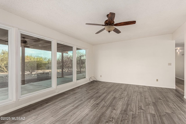 1363 W Dawn Dr, Tucson, AZ 85704 - empty room with dark wood finished floors, ceiling fan, baseboards, and a textured ceiling