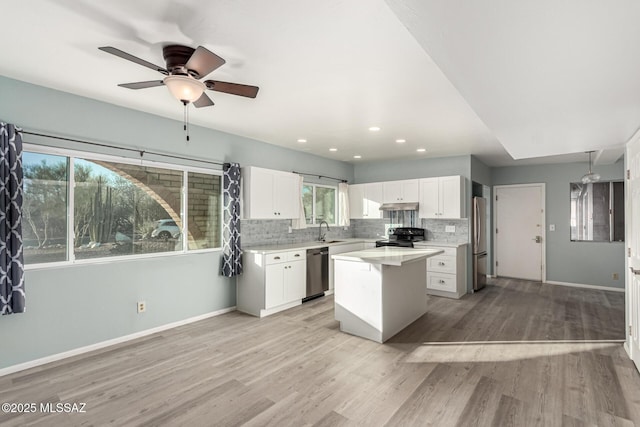 1363 W Dawn Dr, Tucson, AZ 85704 - kitchen featuring appliances with stainless steel finishes, a sink, under cabinet range hood, white cabinetry, and baseboards