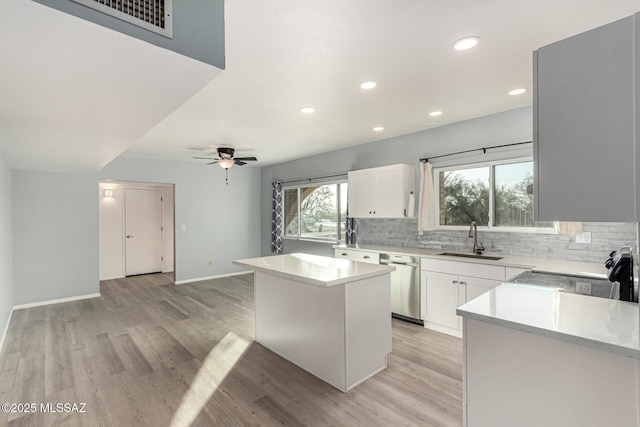1363 W Dawn Dr, Tucson, AZ 85704 - kitchen featuring a sink, stainless steel dishwasher, decorative backsplash, light wood-type flooring, and recessed lighting