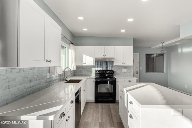 1363 W Dawn Dr, Tucson, AZ 85704 - kitchen with black electric range, a sink, under cabinet range hood, dishwasher, and light wood-style floors