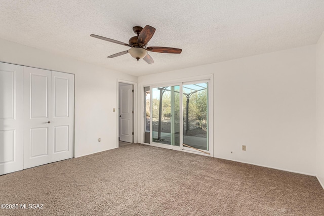 1363 W Dawn Dr, Tucson, AZ 85704 - unfurnished bedroom with carpet floors, access to outside, a closet, a textured ceiling, and a ceiling fan