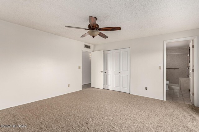 1363 W Dawn Dr, Tucson, AZ 85704 - unfurnished bedroom featuring carpet flooring, a textured ceiling, ensuite bathroom, baseboards, and a ceiling fan
