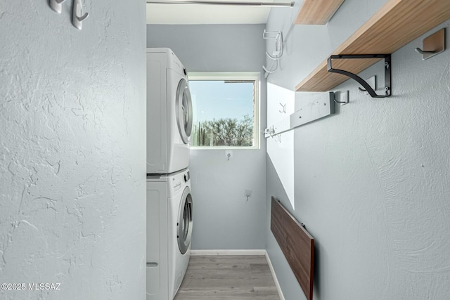 1363 W Dawn Dr, Tucson, AZ 85704 - laundry area featuring estacked washer and dryer, light wood finished floors, and baseboards