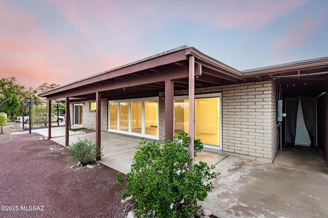 1363 W Dawn Dr, Tucson, AZ 85704 - back of house featuring a patio area and brick siding