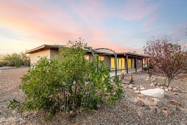 1363 W Dawn Dr, Tucson, AZ 85704 - rear view of house featuring a patio area, a pergola, and brick siding