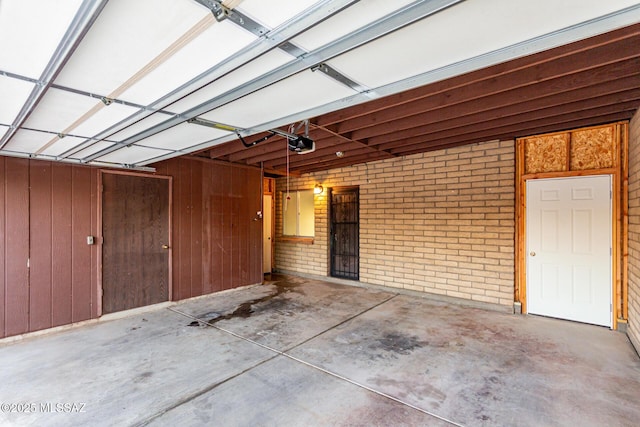 1363 W Dawn Dr, Tucson, AZ 85704 - garage featuring a garage door opener and wood walls