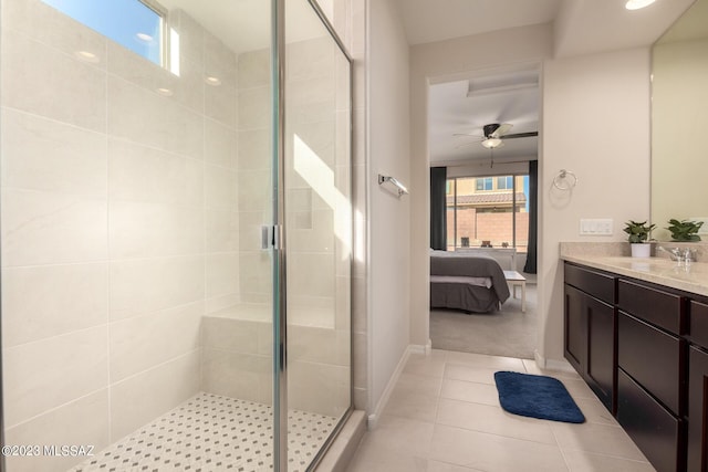 ensuite bathroom featuring a shower stall, tile patterned floors, vanity, ensuite bath, and baseboards