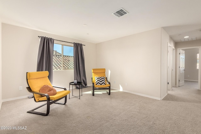 sitting room featuring baseboards, carpet flooring, and visible vents