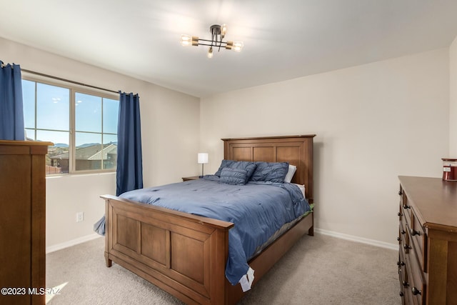 bedroom with baseboards and light colored carpet