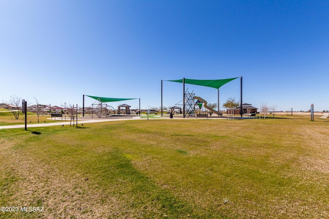 view of community featuring playground community and a lawn