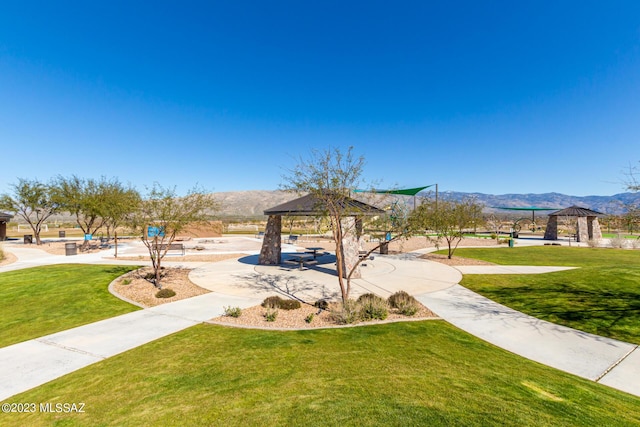 view of home's community with a lawn, a gazebo, and a mountain view