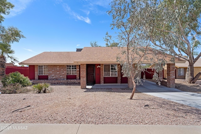 2991 W Basil Pl, Tucson, AZ 85741 - ranch-style house with driveway, fence, brick siding, a carport, and a shingled roof