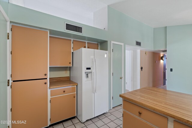 2991 W Basil Pl, Tucson, AZ 85741 - unfurnished bedroom with light colored carpet, lofted ceiling, ensuite bath, and light tile patterned floors