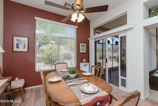 dining area featuring baseboards, visible vents, ceiling fan, and light wood-style floors