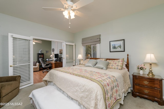 bedroom with a ceiling fan and light colored carpet
