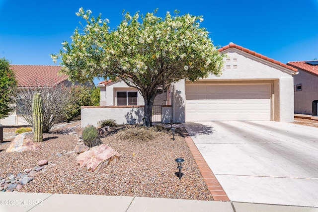 14227 N Willow Bend Dr, Oro Valley, AZ 85755 - view of front facade with driveway, a garage, stucco siding, fence private yard, and a tiled roof