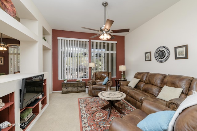 carpeted living area featuring ceiling fan