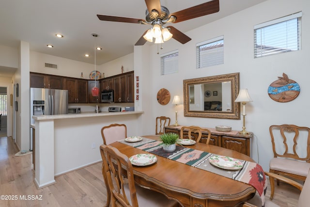 dining space featuring light wood finished floors, a ceiling fan, visible vents, and recessed lighting