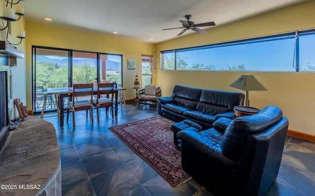 living area with baseboards, a ceiling fan, and recessed lighting