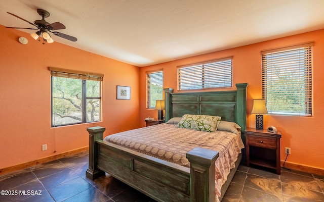 bedroom with baseboards and lofted ceiling