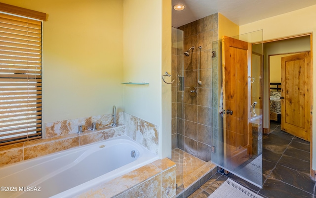 bathroom with a shower stall, recessed lighting, and a bath