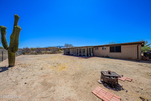 10575 E Placita Diego, Tucson, AZ 85748 - back of house with a sunroom, brick siding, and a fire pit