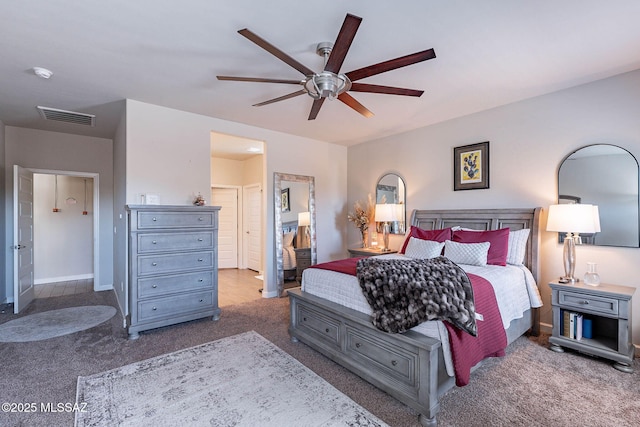 carpeted bedroom featuring visible vents, ceiling fan, and baseboards