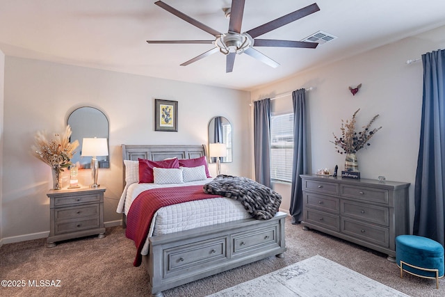 carpeted bedroom with baseboards, visible vents, and a ceiling fan