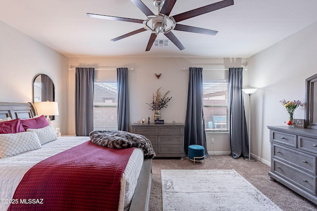 carpeted bedroom featuring visible vents, ceiling fan, and baseboards