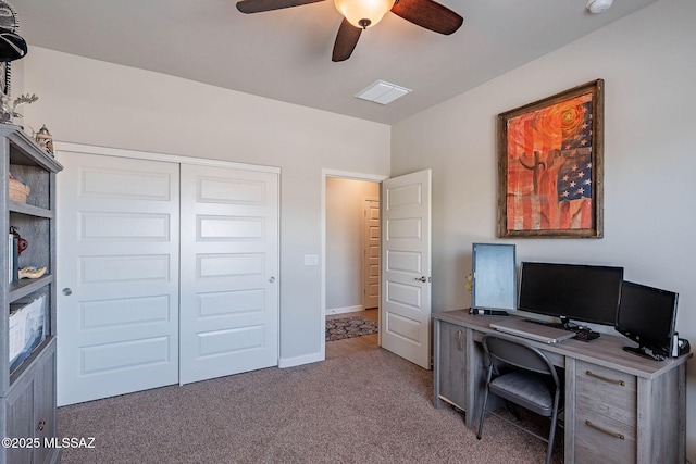 carpeted office space with visible vents and ceiling fan
