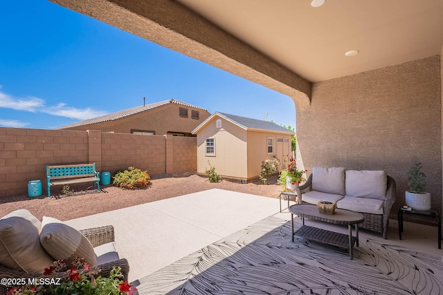 view of patio / terrace featuring an outbuilding, an outdoor hangout area, and fence