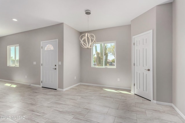 9010 W Bruce St, Tucson, AZ 85735 - interior space with marble finish floor, an inviting chandelier, and baseboards