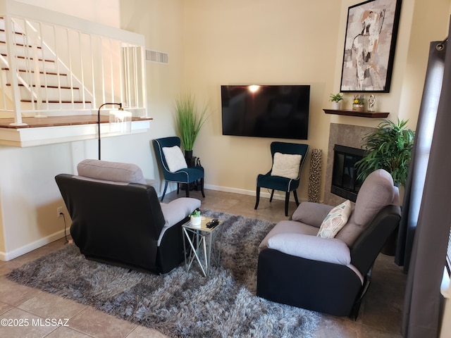 6651 N Campbell Ave Apt 152, Tucson, AZ 85718 - tiled living area with a premium fireplace, stairs, and baseboards