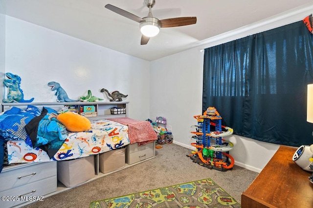 carpeted bedroom featuring baseboards and ceiling fan