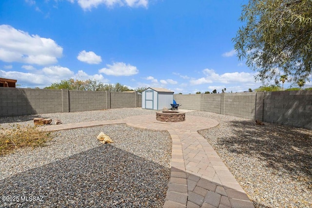 view of yard featuring a fenced backyard, a storage unit, an outbuilding, and a patio area