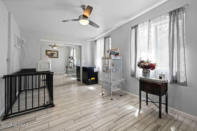 interior space featuring baseboards, ceiling fan, and wood finish floors