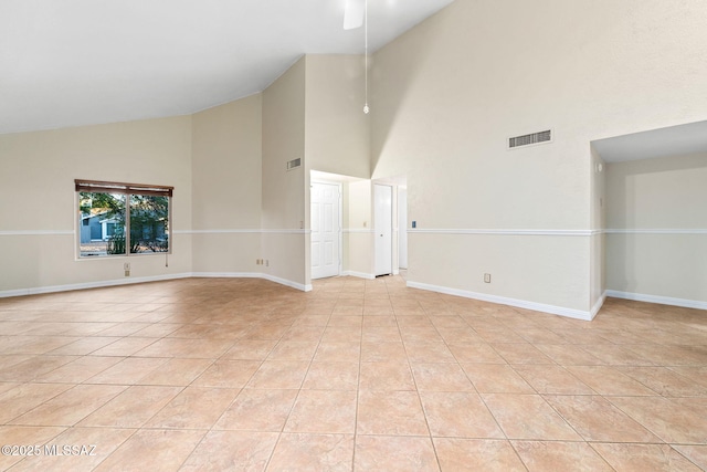 unfurnished living room featuring visible vents, ceiling fan, high vaulted ceiling, and baseboards