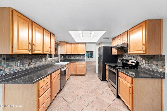 kitchen featuring light tile patterned floors, stainless steel appliances, under cabinet range hood, and decorative backsplash
