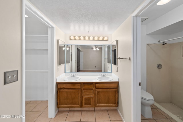 bathroom with a walk in shower, tile patterned flooring, and a sink