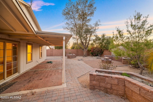 view of patio with a fire pit and a fenced backyard