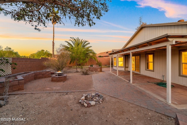 view of yard featuring a patio, an outdoor fire pit, and a fenced backyard
