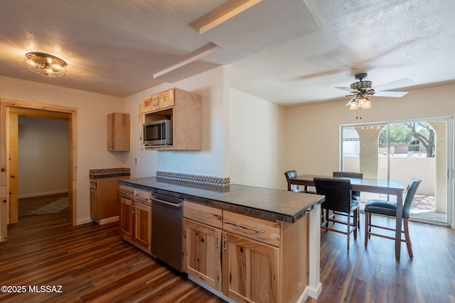 912 S Las Lomas Cir, Green Valley, AZ 85614 - kitchen with dark wood-style flooring, dark countertops, stainless steel appliances, and a textured ceiling