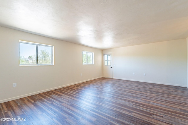 912 S Las Lomas Cir, Green Valley, AZ 85614 - unfurnished room featuring dark wood-type flooring and baseboards