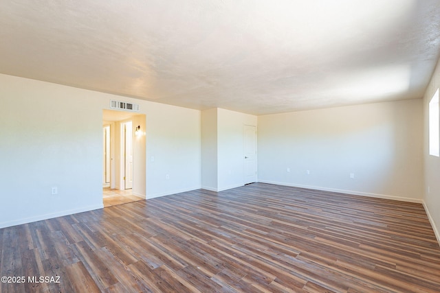 912 S Las Lomas Cir, Green Valley, AZ 85614 - unfurnished room with visible vents, dark wood-style flooring, and baseboards