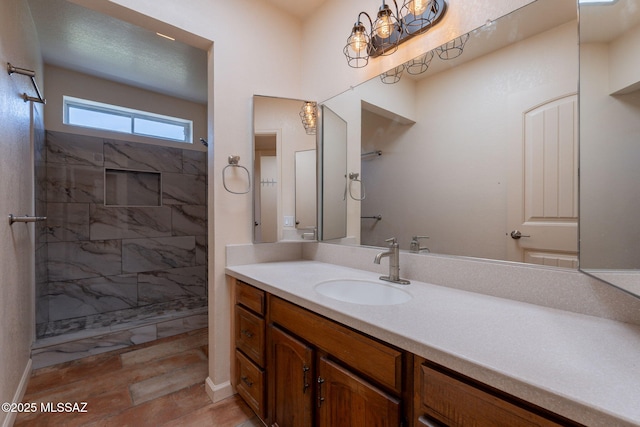 912 S Las Lomas Cir, Green Valley, AZ 85614 - bathroom featuring vanity, baseboards, and tiled shower